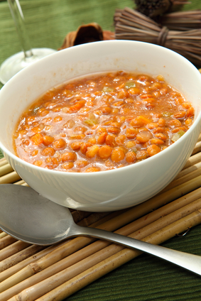 a white bowl of red lentil soup