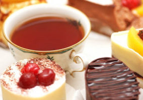 Sweet cake with berries and a cup of tea