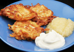 Traditional Chanukah Potato Latkes Potato latkes for Hanukkah, served with sour cream and applesauce .
