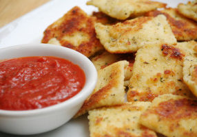 Fried Ravioli on White Plate With a Bowl of Marinara Sauce