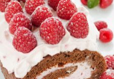 Homemade roulade with raspberries and whipped sour cream. Shallow dof.